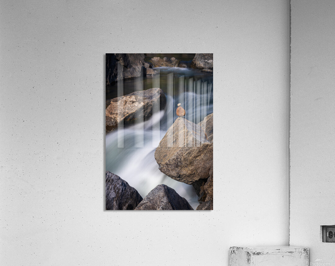 Pebbles balanced on rocks in raging river illustrating resilienc Acrylic Print
