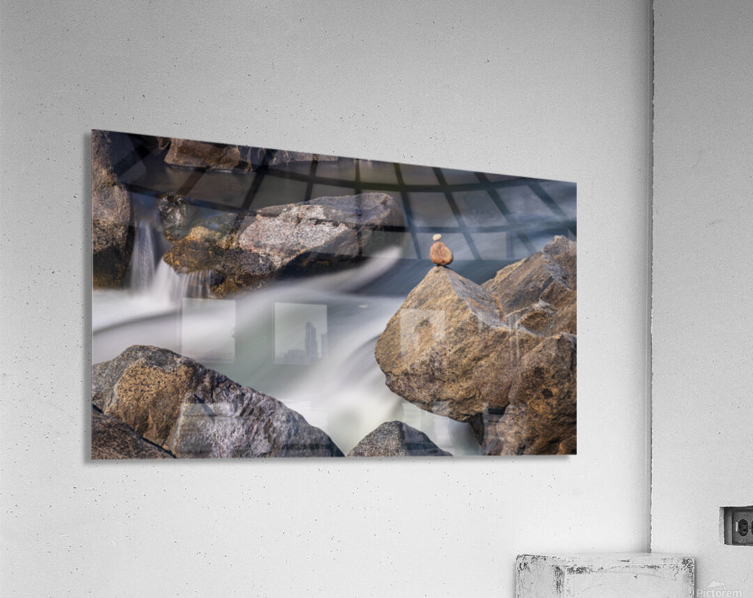 Pebbles balanced on rocks in raging river illustrating resilienc Acrylic Print