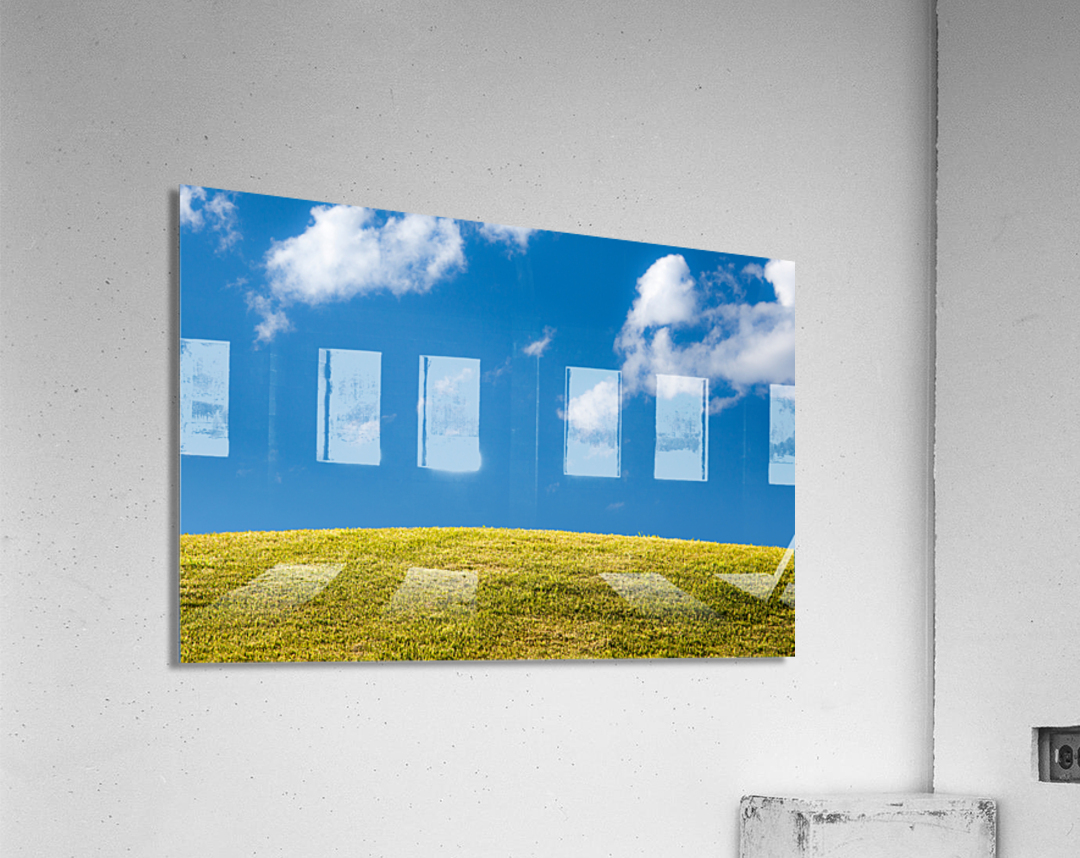 Green grassy lawn with blue sky and clouds Acrylic Print