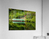 Green canoe on dock reflecting into calm lake or pond in garden  Acrylic Print