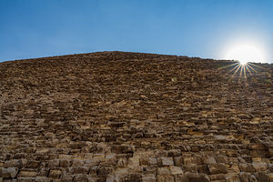 Great Pyramid of Giza with the sun flaring over the top edge