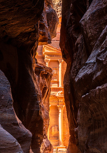 Petra Treasury building facade seen through narrow gorge