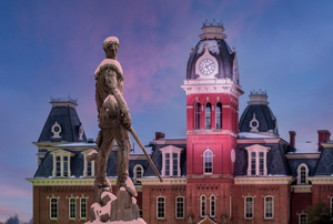 Mountaineer statue against Woodburn Hall tower