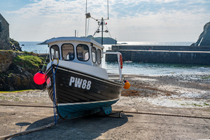 Fishing boat in old harbour at Mullion Cove in Cornwall