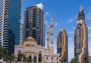 Mosque among towers on the waterfront at Dubai Marina UAE