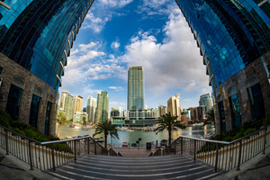 Fisheye view of tall buildings on waterfront at Dubai Marina