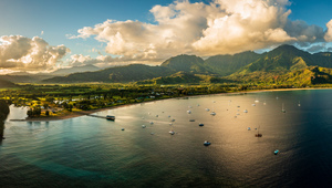 Aerial panorama over the town of Hanalei and valley at sunrise