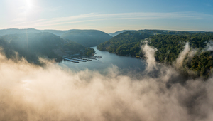 Mist rises from Cheat Lake in the early morning as the sun rises