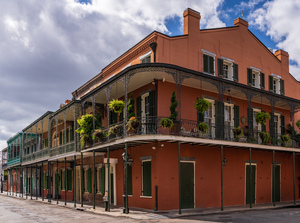 Traditional wrought iron balcony on ochre New Orleans house