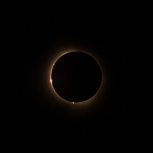Solar eclipse with the light being seen through lunar canyons.