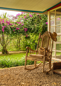 Portrait format of vintage wooden rocking chair on a porch