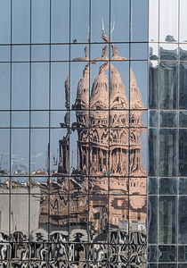 Intricate reflections of the Texas state capitol building on a s