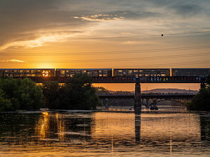 Freight train on the railroad bridge in Austin at sunset