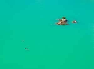Three paddleboards float away from island in Diablo Lake in Nort