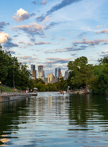 View of the Austin skyline at sunset over Barton Springs swimmin