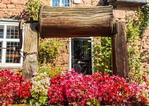 Wooden well winch frames welcome sign