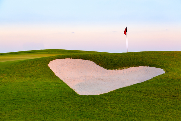 Heart shaped sand bunker in front of golf green by Steve Heap