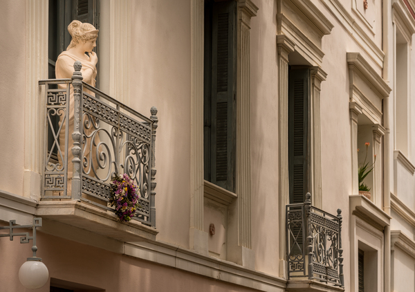 Statue on balcony in Plaka in Athens by Steve Heap