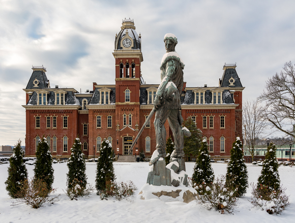 Mountaineer statue against Woodburn Hall by Steve Heap