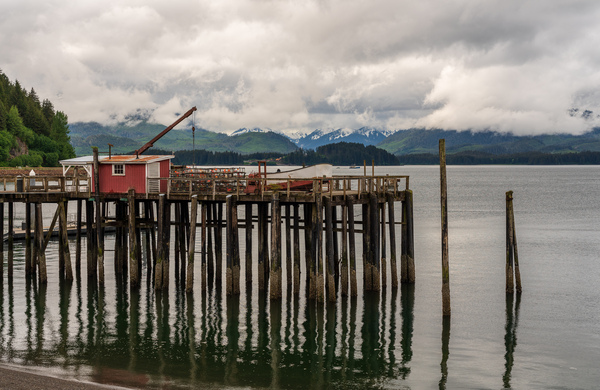 Old wooden pier structure in bay at Icy Strait Point in Alaska by Steve Heap