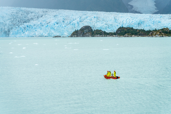 Small boat approaching Amalia Glacier to collect iceberg by Steve Heap