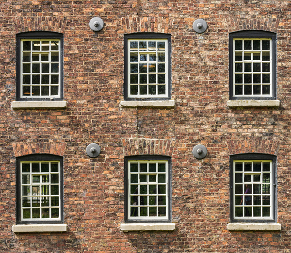 Restored industrial cotton mill with pattern of windows by Steve Heap