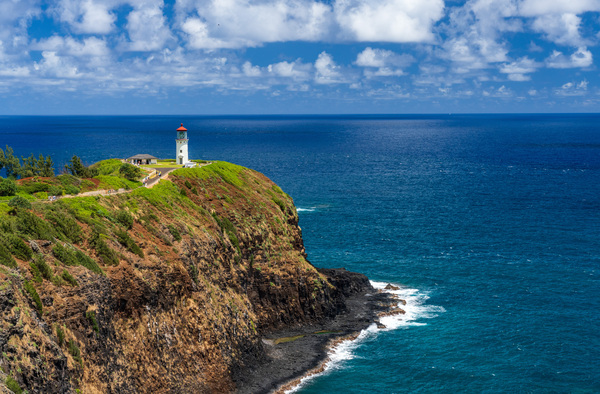 Kilauea lighthouse on headland against blue sky on Kauai by Steve Heap