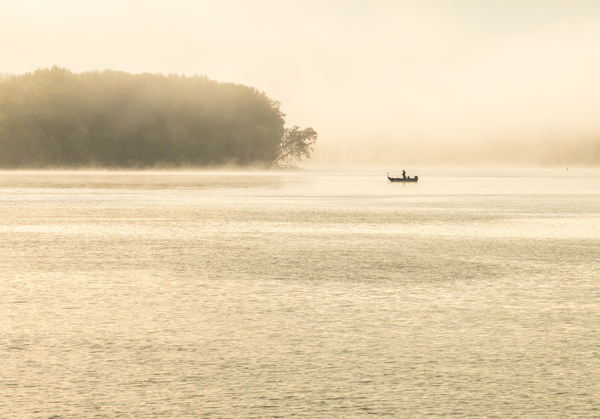 Fisherman fishing in Mississippi river on misty autumn morning by Steve Heap