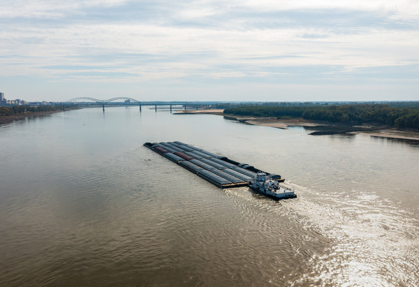 Large barge boat sails under Memphis bridge in October 2023 by Steve Heap
