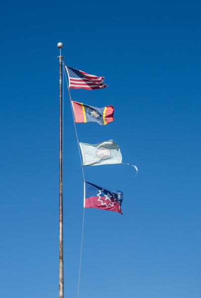 Flagpole with multiple flags in the small town of Greenville MS by Steve Heap
