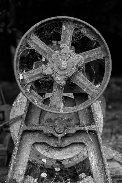 Rusty farm machinery with flywheel by Steve Heap