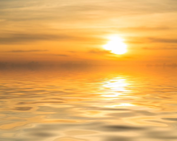 Sunset over calm ocean or sea by Steve Heap