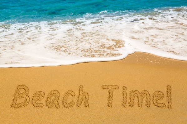 Beach Time written in sand with sea surf by Steve Heap