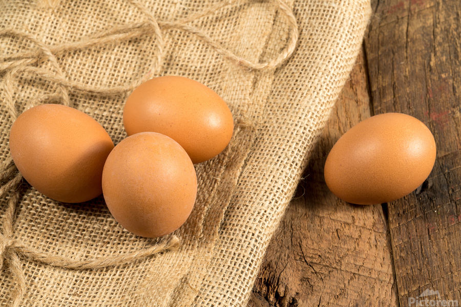 Freshly laid organic eggs on wooden bench  Print