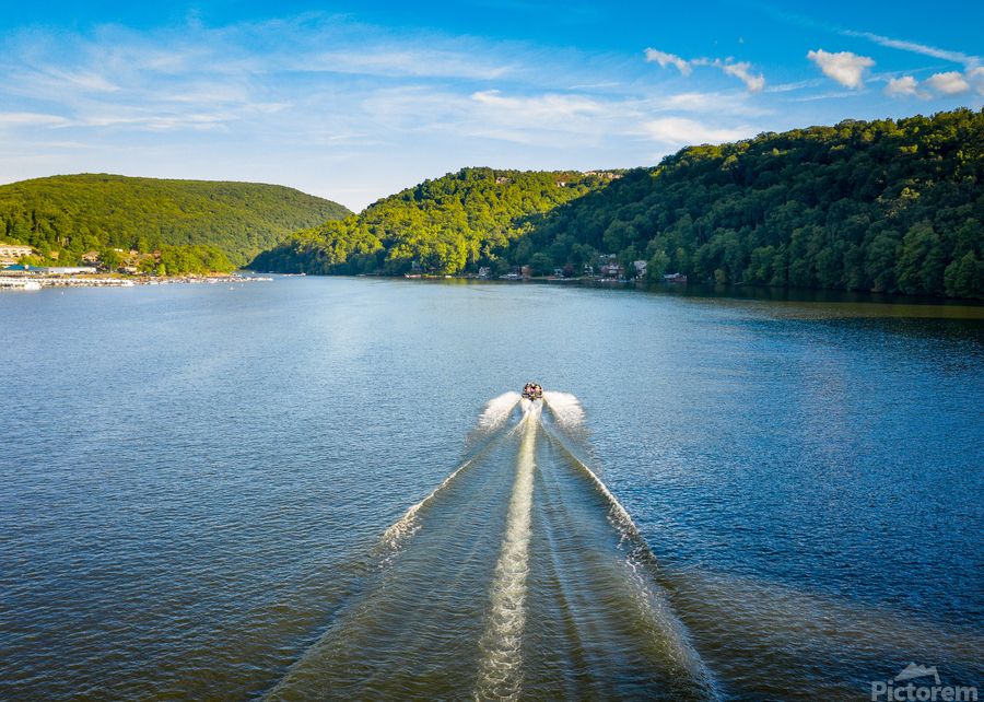Speedboat on Cheat Lake on a summer evening with boats docked in  Print