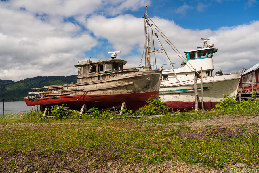 Historic but rotting fishing boats by ocean at Icy Strait Point  Print