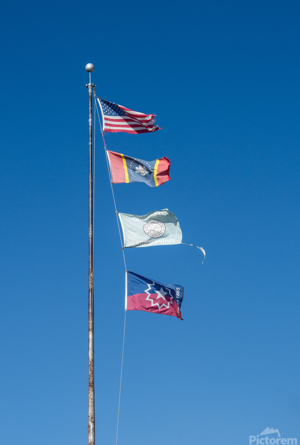 Flagpole with multiple flags in the small town of Greenville MS  Print