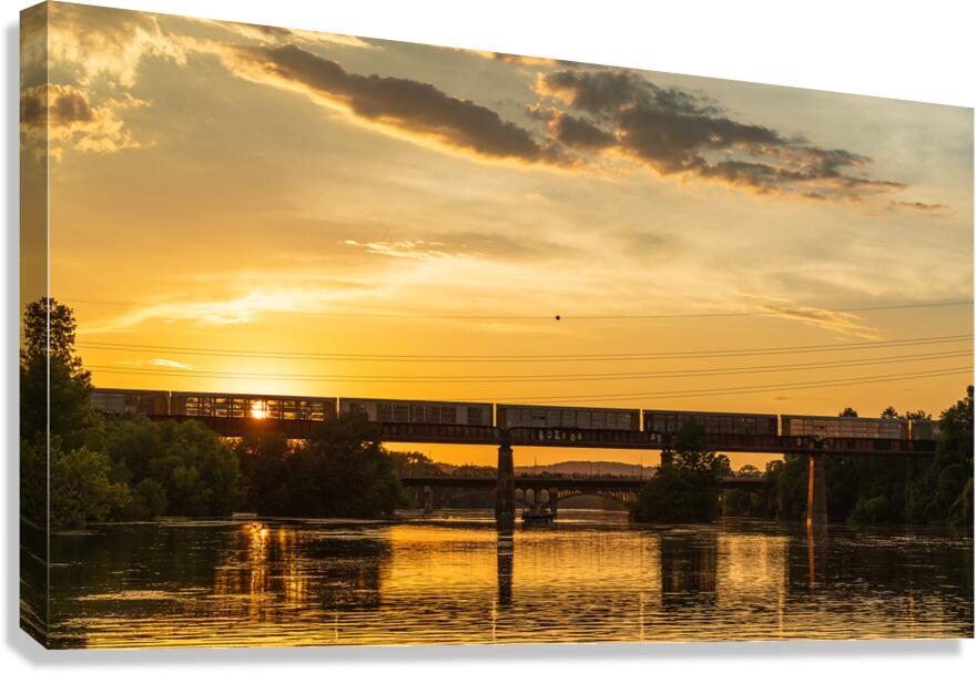 Freight train on the railroad bridge in Austin at sunset Canvas Print