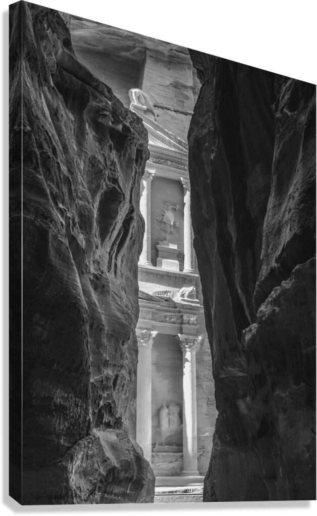 Monochrome Petra Treasury building facade seen through narrow go Canvas Print