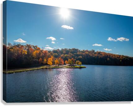 Sunburst above fall trees around the water at Cheat Lake Park  Canvas Print
