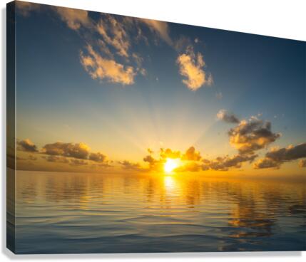 Beautiful sunset reflected in a calm peaceful ocean  Canvas Print