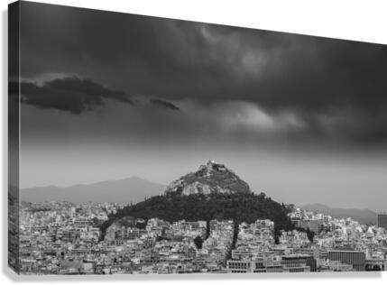 Lycabettus hill rises above Athens in a storm  Canvas Print