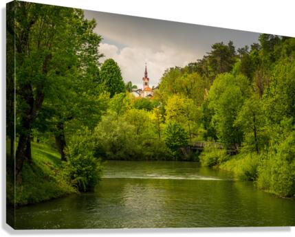 Church in the woods above peaceful river  Canvas Print