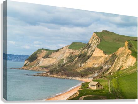 Cottage by cliffs at West Bay Dorset in UK Canvas Print
