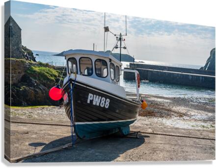 Fishing boat in old harbour at Mullion Cove in Cornwall  Canvas Print