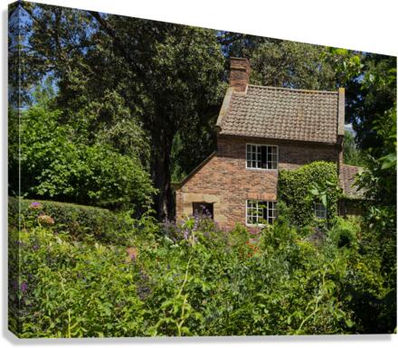 Cottage garden of small brick home  Canvas Print