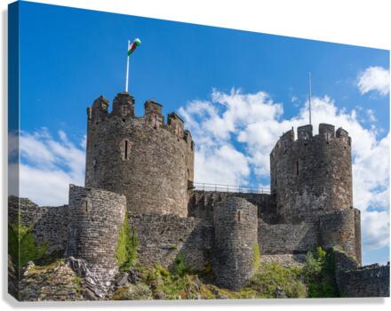 Flag flies over the historic Conwy castle in North Wales Canvas Print