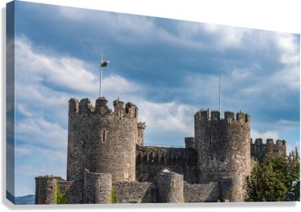 Flag flies over the historic Conwy castle in North Wales  Canvas Print