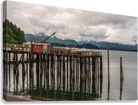 Old wooden pier structure in bay at Icy Strait Point in Alaska  Canvas Print