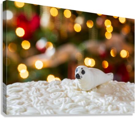 Seal on Christmas cake with tree lights  Canvas Print